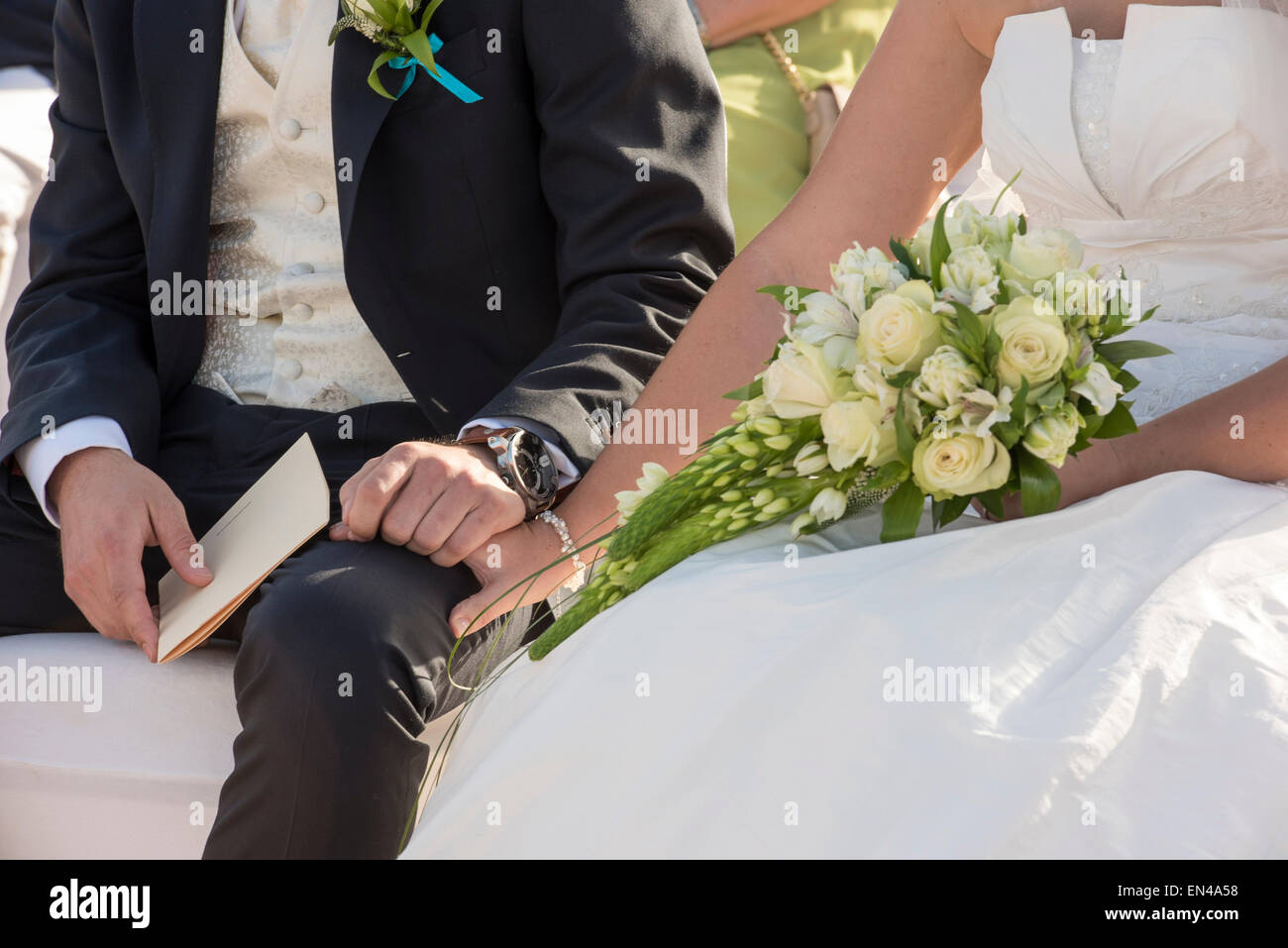 Bride and groom sitting hi-res stock photography and images - Alamy