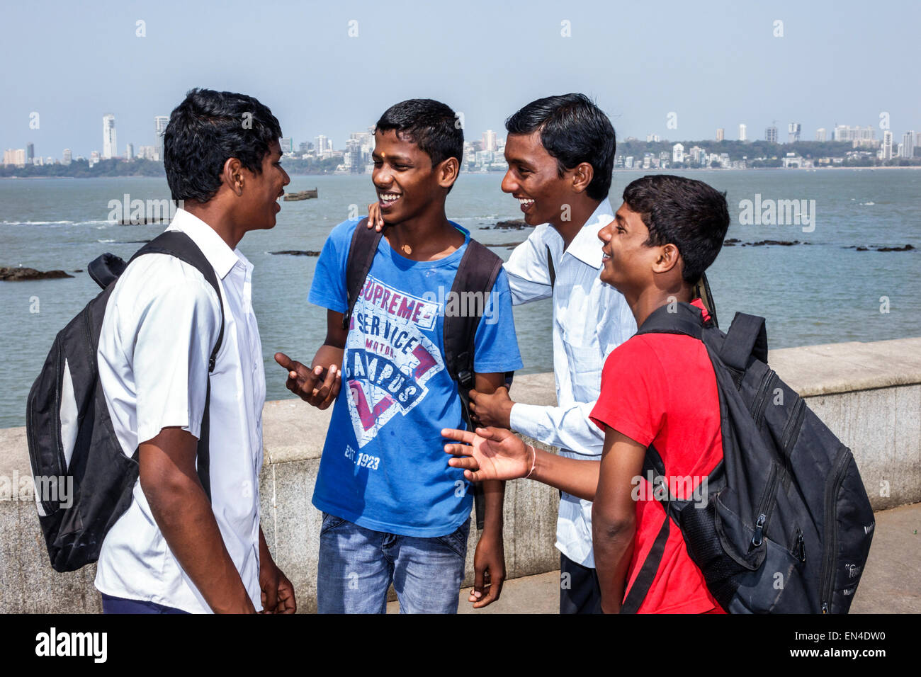 Mumbai India,Churchgate,Marine Drive,Back Bay,Arabian Sea,teen teens teenager teenagers male boy boys kids children student students friends,talking,I Stock Photo