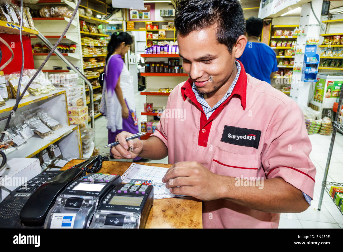 Mumbai India,Churchgate,Suryodaya inside interior grocery store supermarket man,employee worker working credit card scanner using wearing wears unifor Stock Photo