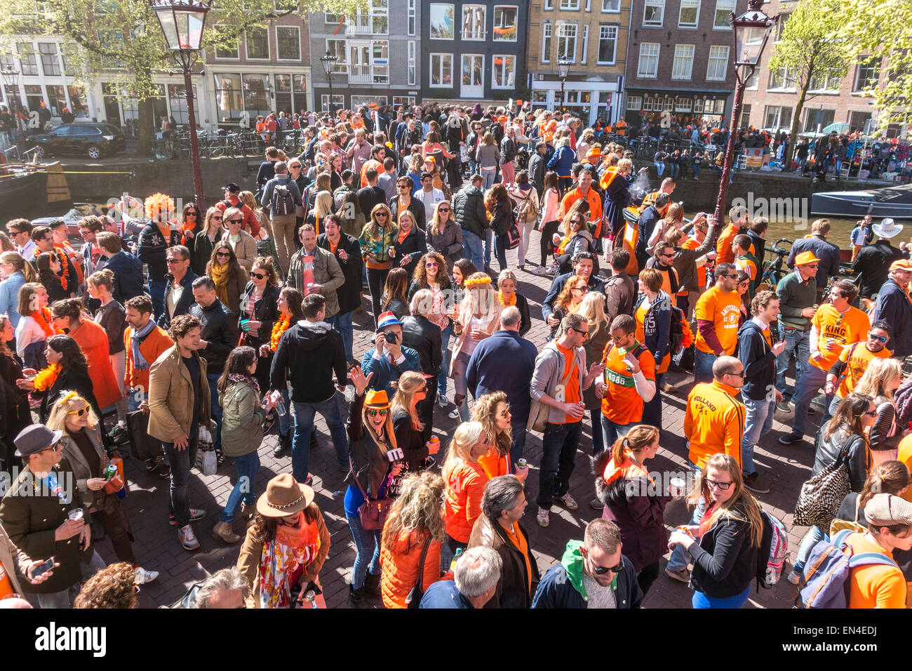 Crowds of people on a bridge celebrating Koningsdag, Kings Day in Amsterdam on Prinsengracht Canal. Stock Photo