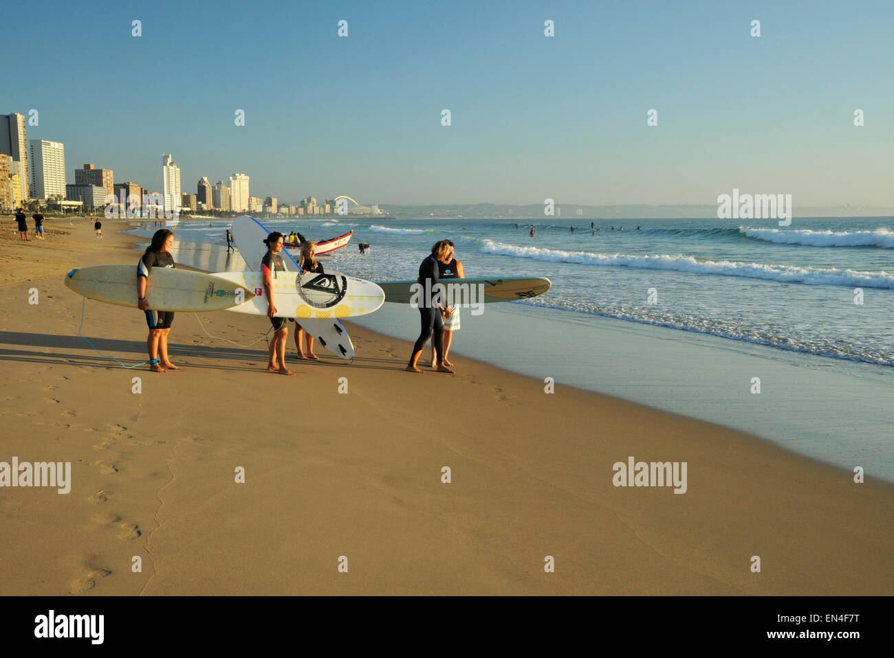 Group of adult surfers on beach of famous Durban Golden Mile beachfront
