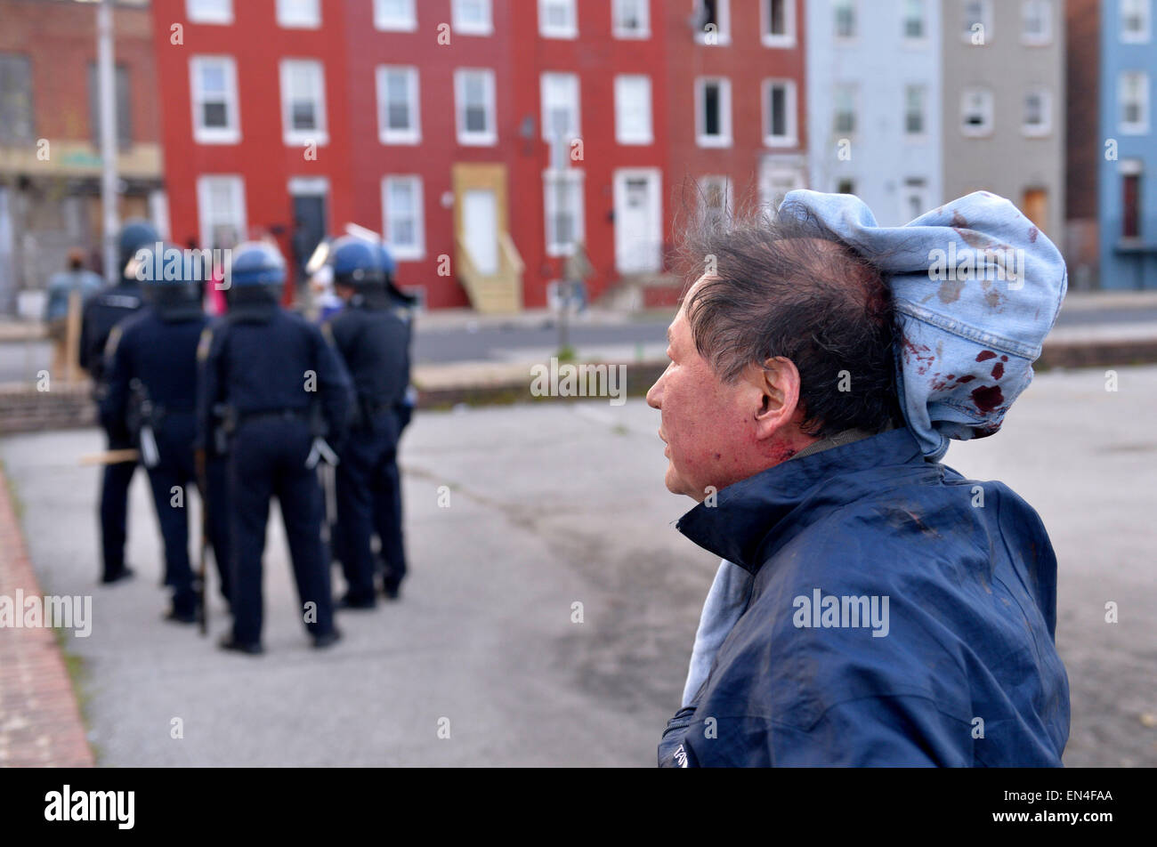 Baltimore, USA. 27th Apr, 2015. A man is injured on the head by looters in Baltimore, Maryland, the United States, April 27, 2015. Maryland governor Larry Hogan Monday evening declared a state of emergency and activated the National Guard to address the escalating violence and unrest in Baltimore City following the funeral of a 25-year-old black man who died after he was injured in police custody. Credit:  Yin Bogu/Xinhua/Alamy Live News Stock Photo