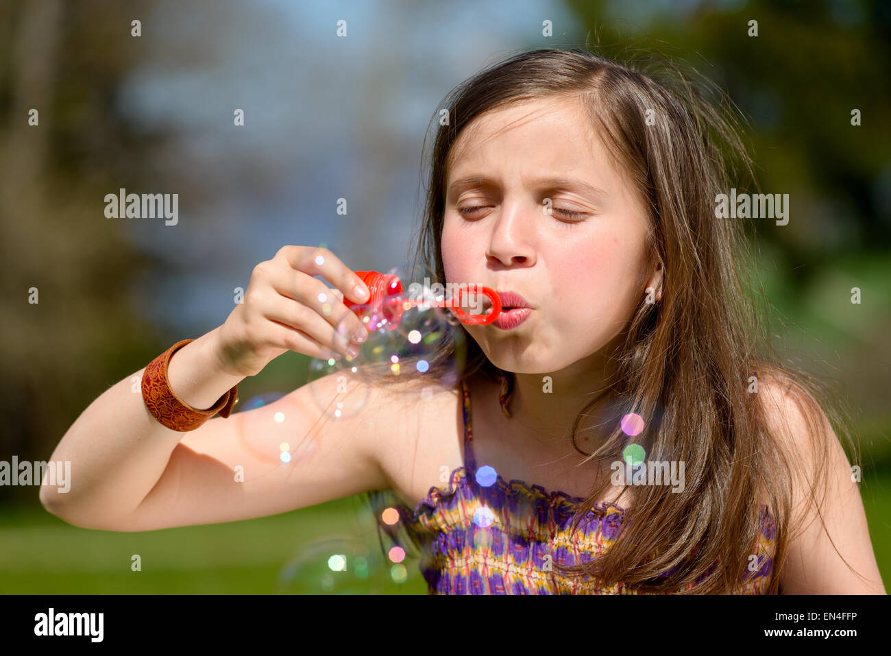 a little girl making soap bubbles in nature Stock Photo - Alamy