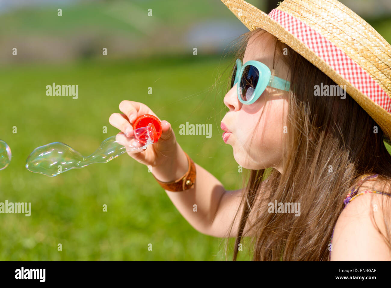 a little girl making soap bubbles in nature Stock Photo - Alamy