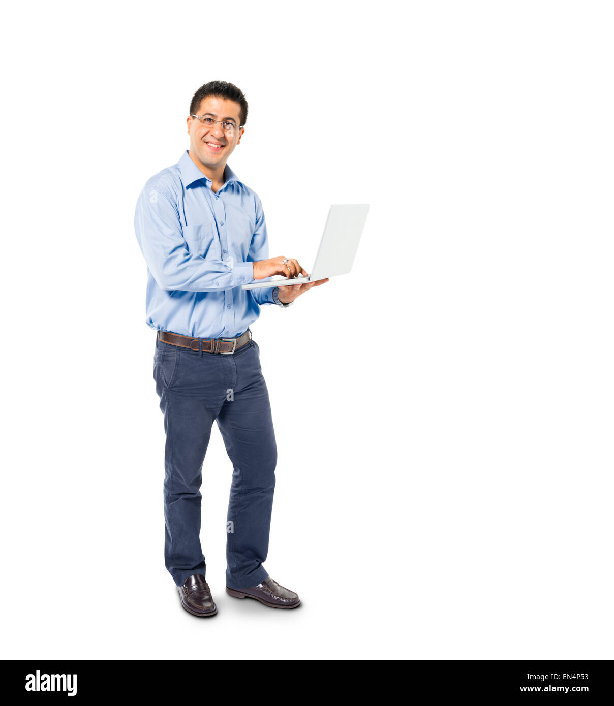 A Smart Casual Mans Standing while using his Laptop Stock Photo
