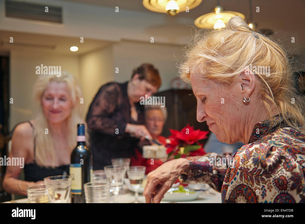 Attractive mature women at a New Year's Eve family dinner party, with; in Brussels, Belgium. Stock Photo