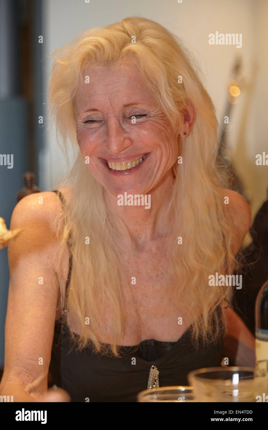 An attractive mature woman at a New Year's Eve family dinner party; in Brussels, Belgium. Stock Photo