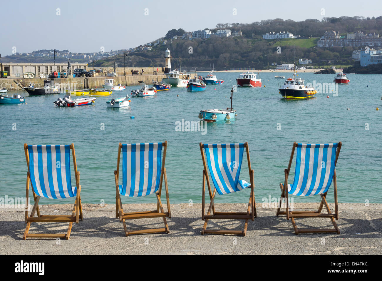 Deckchairs on the harbour sea front in St. Ives, Cornwall England. Stock Photo