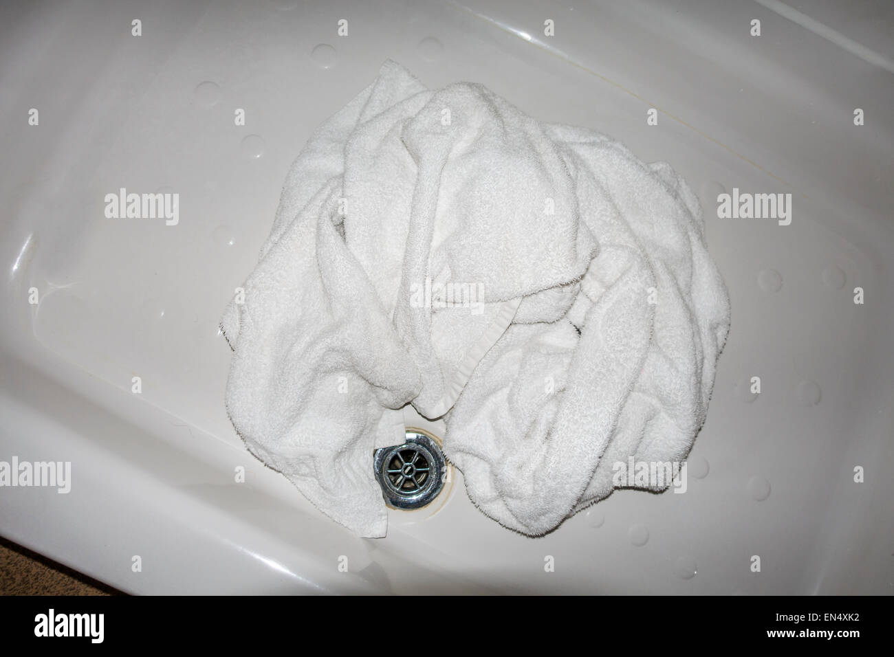 Used Hotel Towel in Shower for Changing Stock Photo