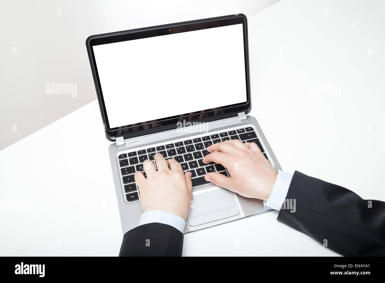 businessman typing on laptop on white desk Stock Photo