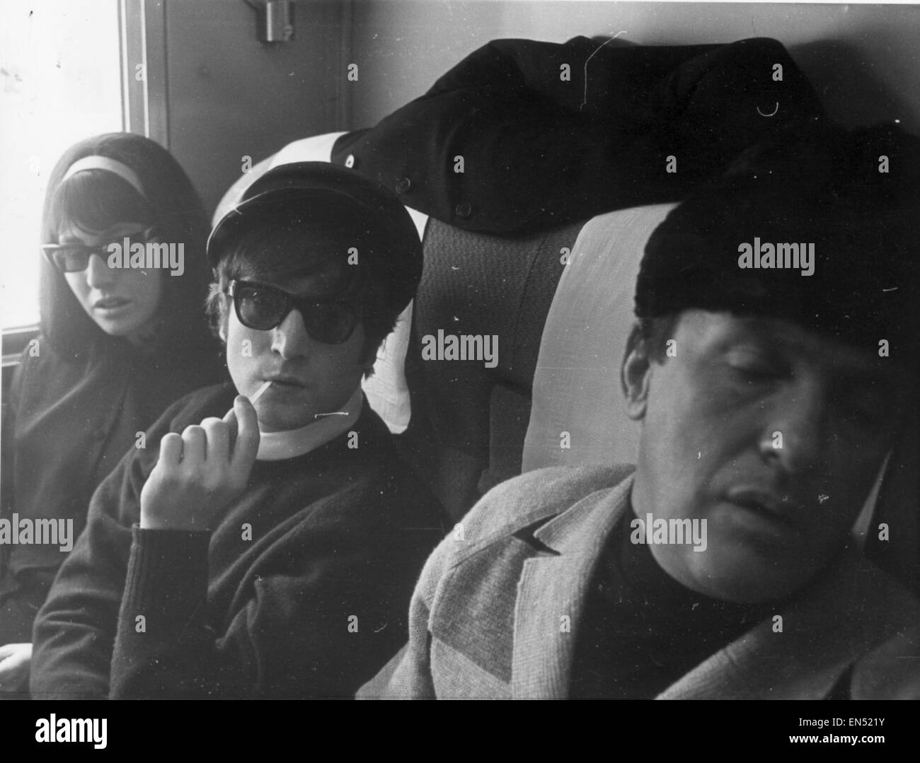 John Lennon & wife Cynthia Lennon on board train for Washington D.C. February 1964. Evaluation Scan Only - If you require a high resolution copy, please contact desk@mirrorpix.com Stock Photo