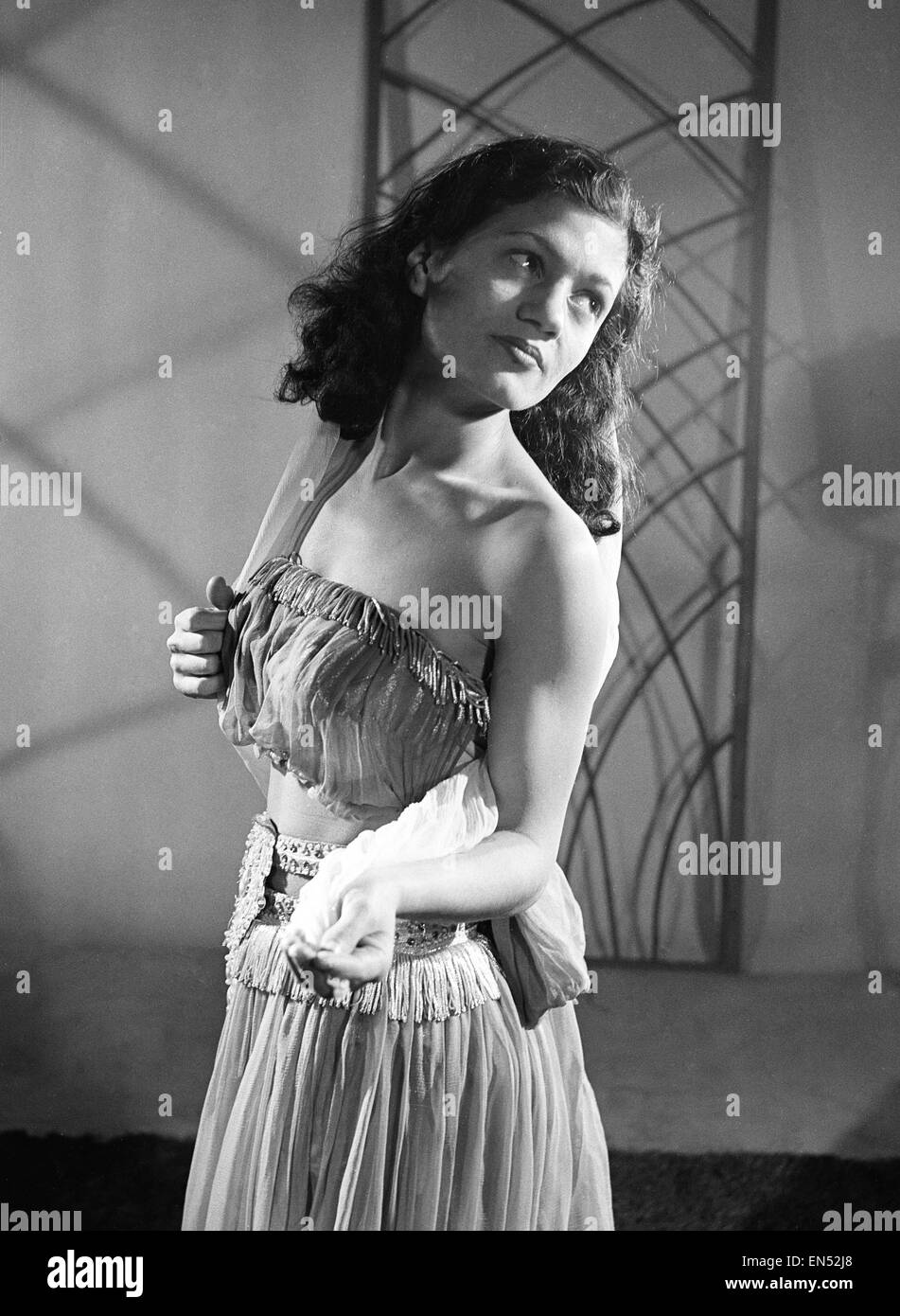 Kawahkib, an Arab slave girl who was smuggled into England from Iraq by young British seaman Tommy Flynn, pictured playing her part in the Christmas pantomime 'Aladdin and His Magic Lamp'. 10th December 1953. Stock Photo