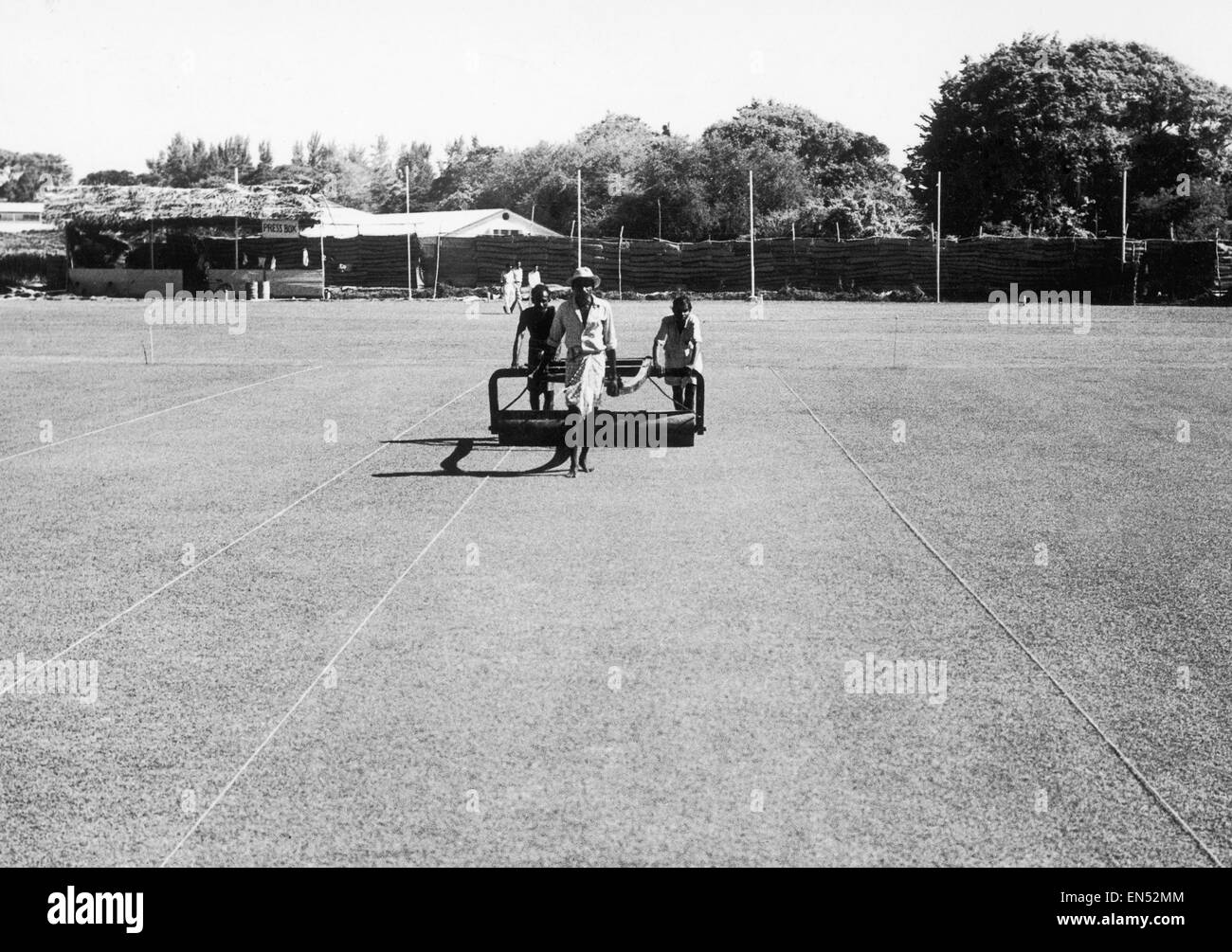 Groundsmen prepare the field at Sinhalese Sports Club grounds in Colombo, Sri Lanka where the MCC team will play 2 matches against Ceylon teams. Temporary sheds have been erected to accomodate spectators. October 1958. Stock Photo