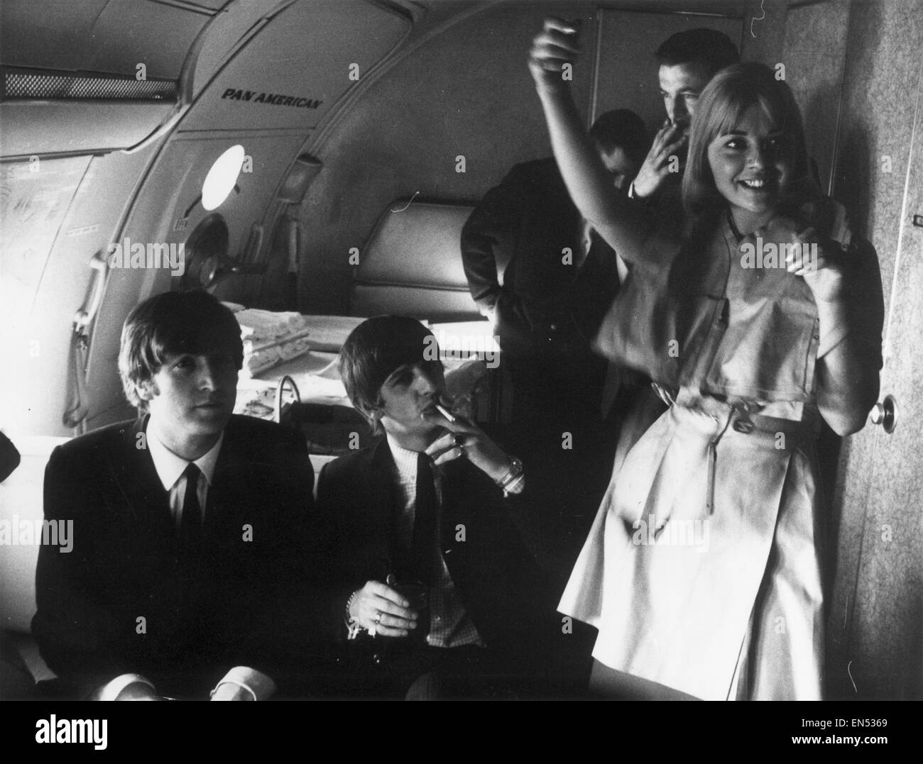 The Beatles on Pan Am Flight 101 from London Heathrow Airport to New York for a 10 day tour of the United States of America 7th February 1964. John Lennon & Ringo Starr Evaluation Scan Only - If you require a high resolution copy, please contact desk@mirr Stock Photo