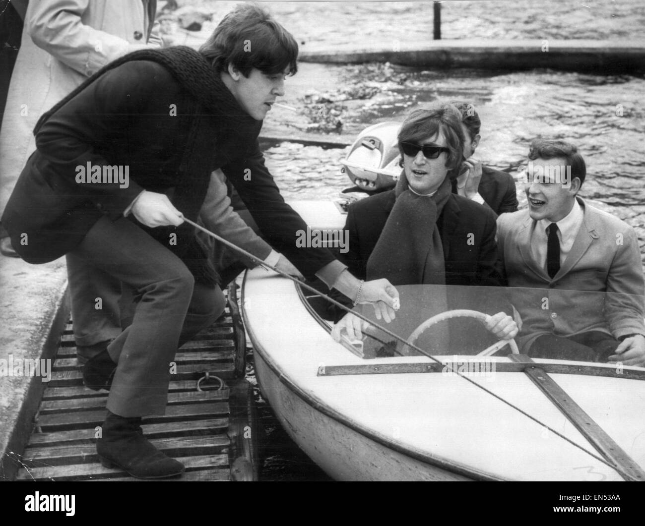 Paul McCartney pulls boat into jetty after John Lennon had been for a sail on Loch Earn in Scotland 20th October 1964. Pictured during stay in Beatles hideaway in St Fillans Perthshire. Evaluation Scan Only - If you require a high resolution copy, please Stock Photo