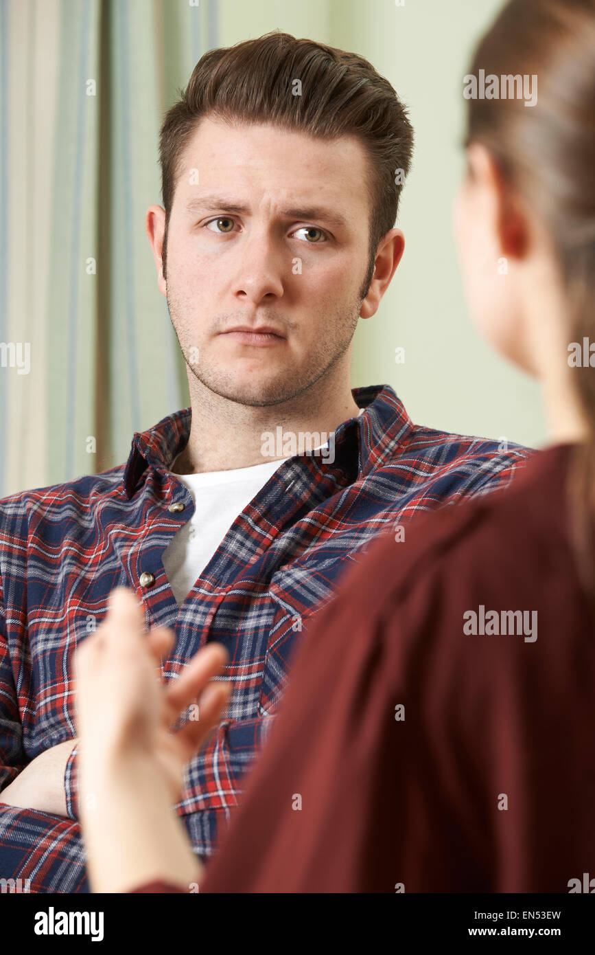 Depressed Young Man Talking To Counsellor Stock Photo