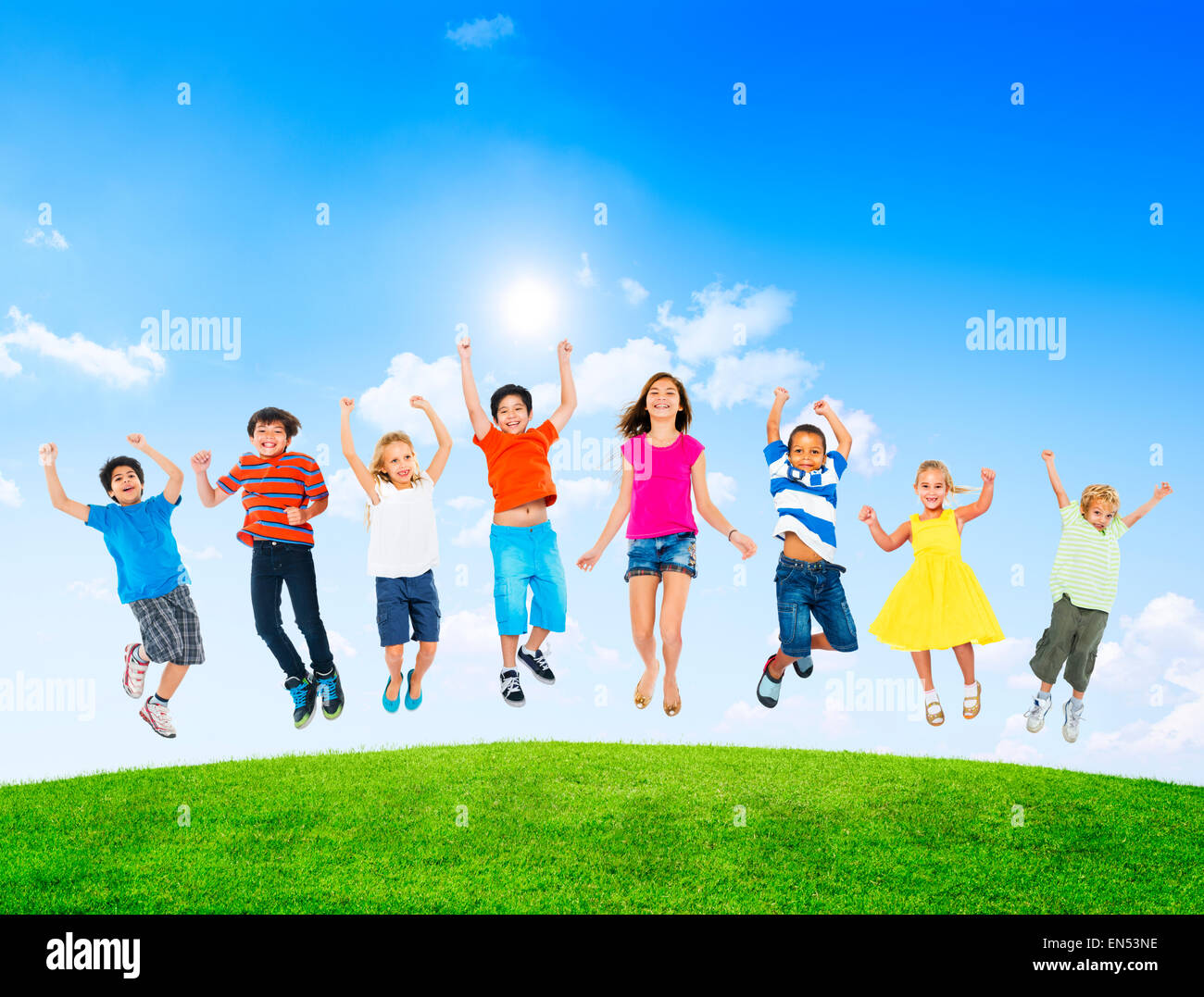 Group of Diverse Multi-Ethic Children Jumping Outdoors Stock Photo