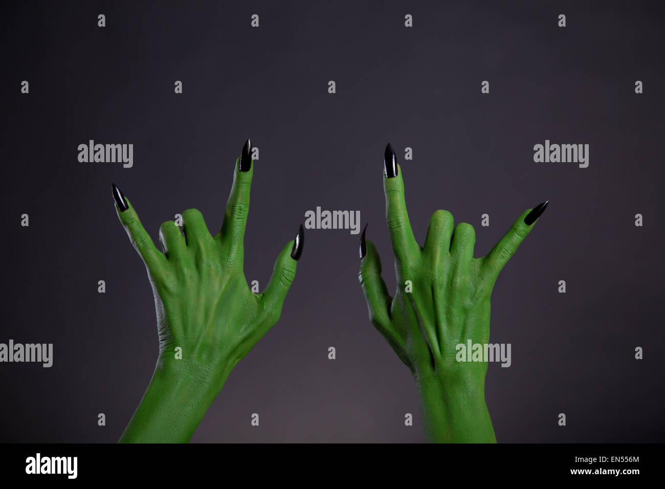 Green monster hands showing heavy metal gesture, Halloween theme Stock