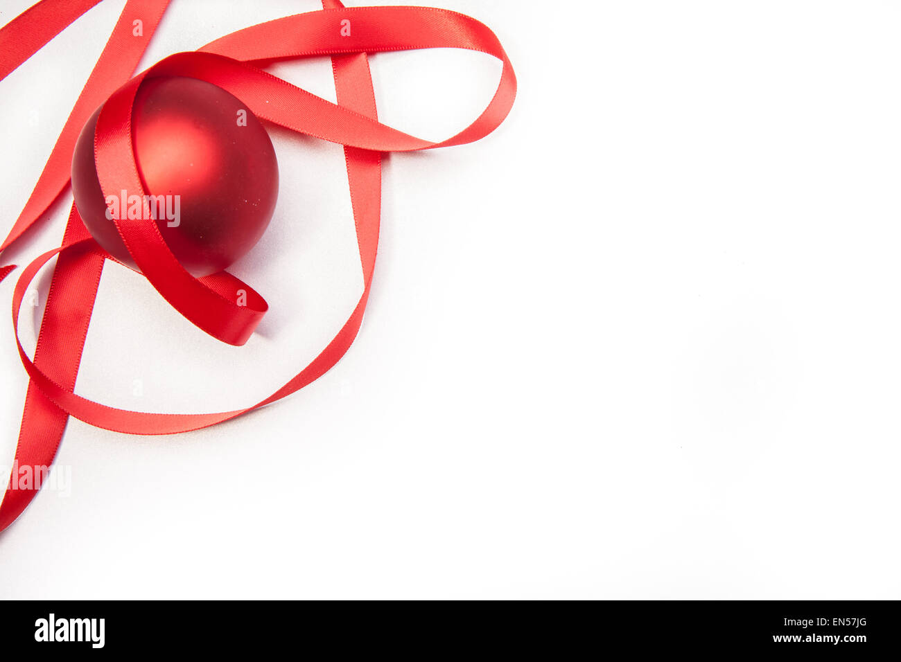 A Christmas ball and a red ribbon on a white background Stock Photo - Alamy