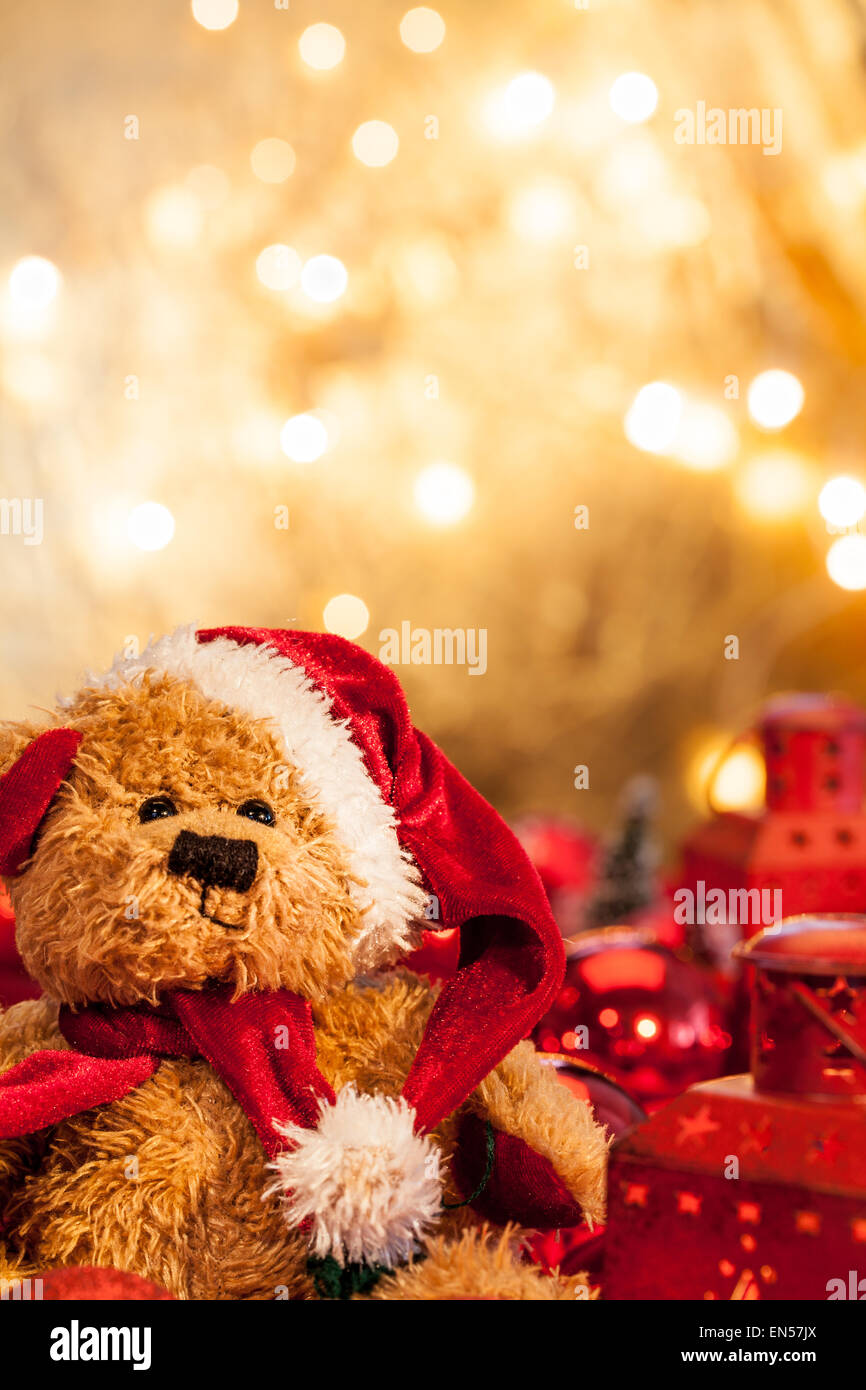 A teddy bear dressed as Santa Claus with a golden background Stock ...