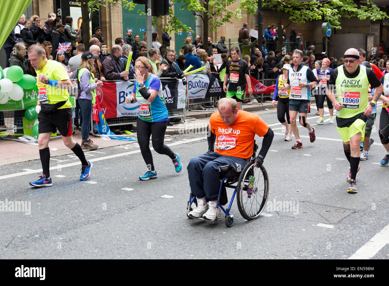 Wheelchair charity runner, running at the 2015 Virgin Money London Marathon Stock Photo