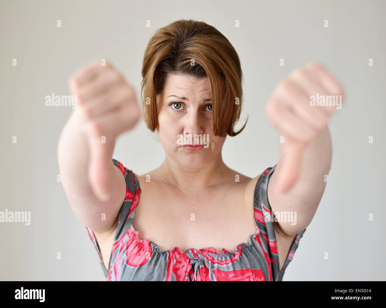 angry young woman showing her thumb down Stock Photo