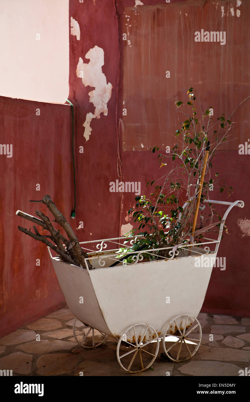 An ornate garden trolley of a house in Syros in Greek Islands Stock Photo