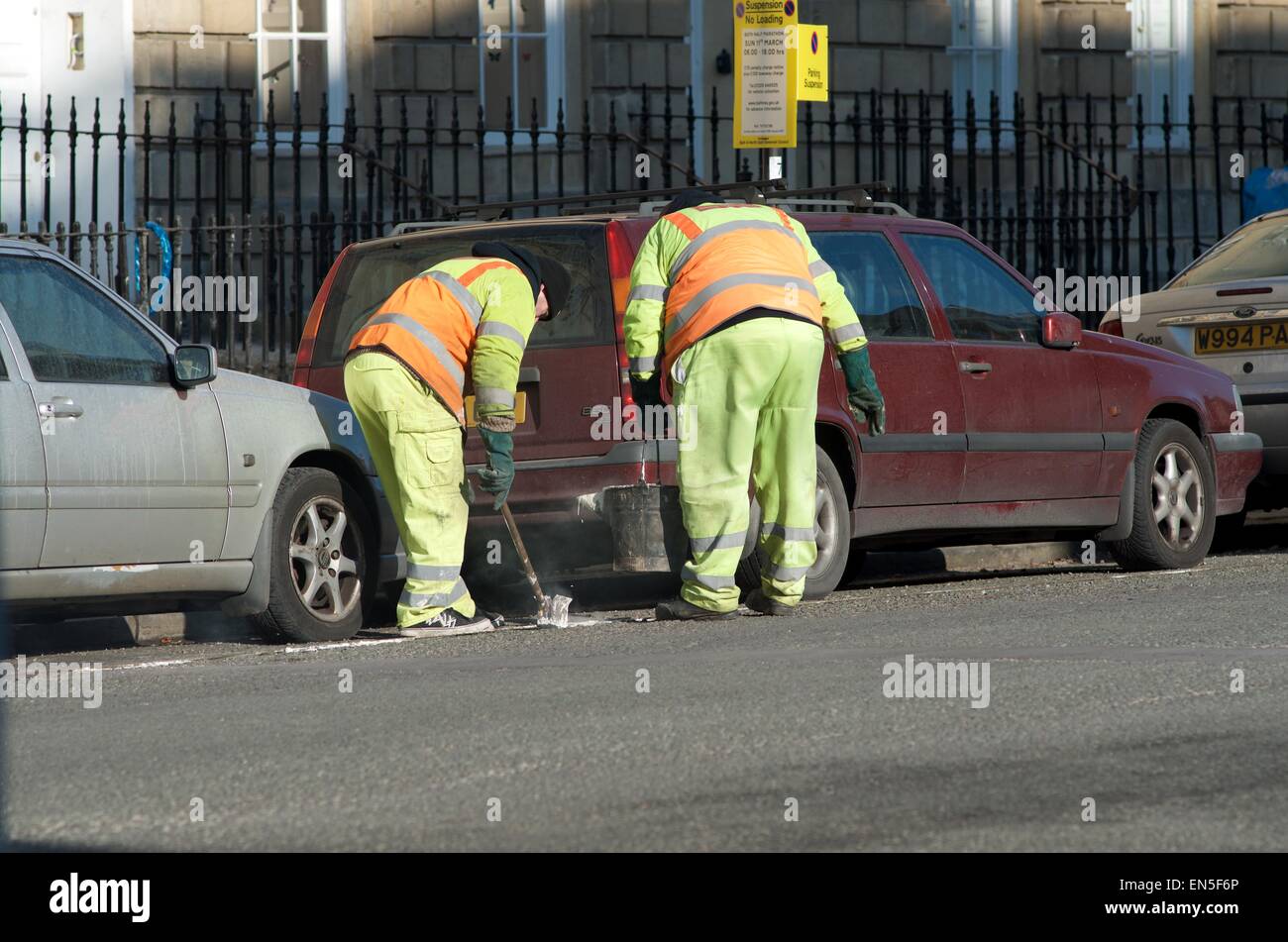 Men Line Painting in Road Stock Photo