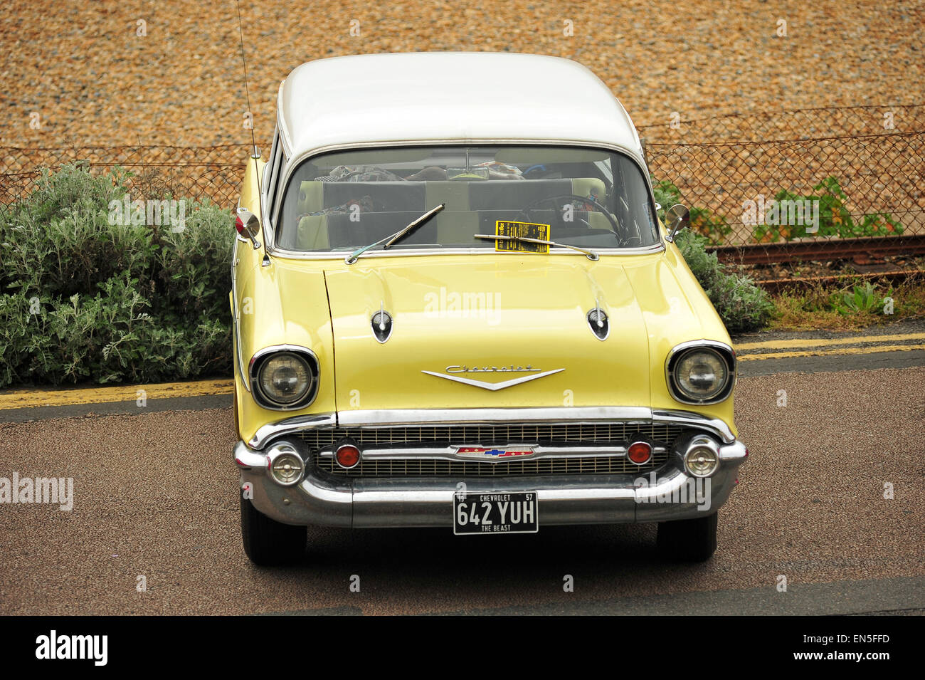 A pale yellow Chevrolet Bel Air parked along Madeira Drive in Brighton during a car show. Stock Photo
