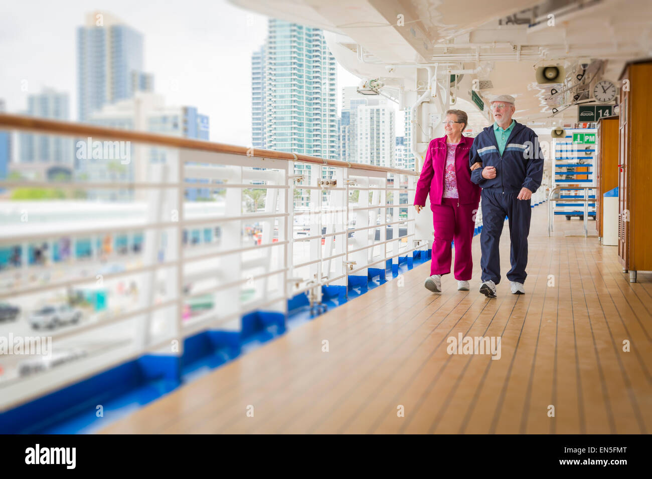 Happy Senior Couple Walking The Deck of a Luxury Passenger Cruise Ship. Stock Photo