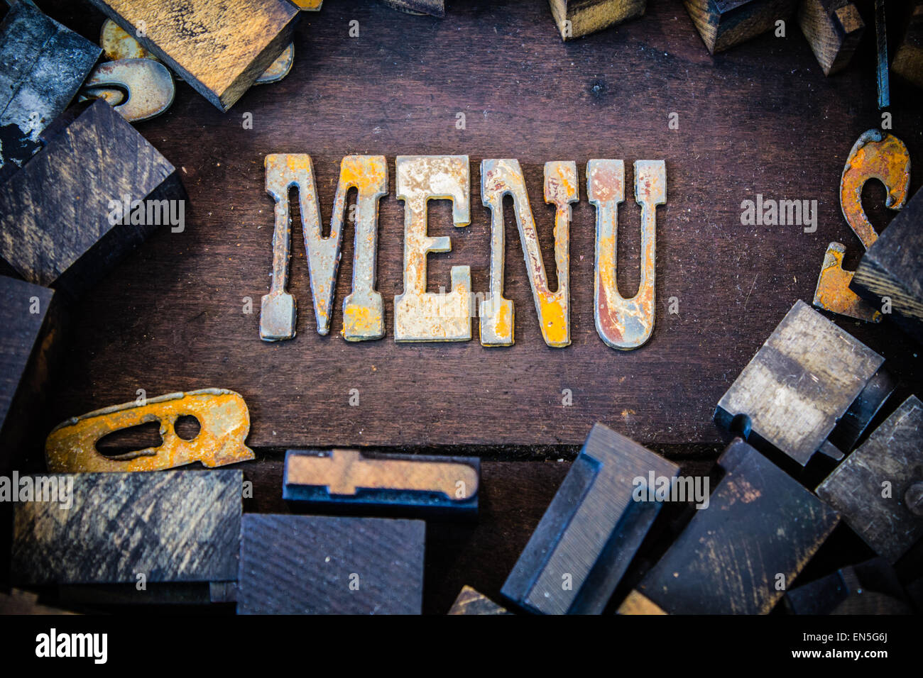 The word menu written in rusted metal letters surrounded by vintage ...