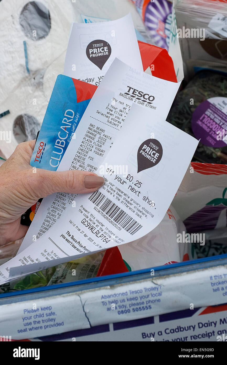 Shopping - a customer shopper holding receipts from a Tesco supermarket. Stock Photo