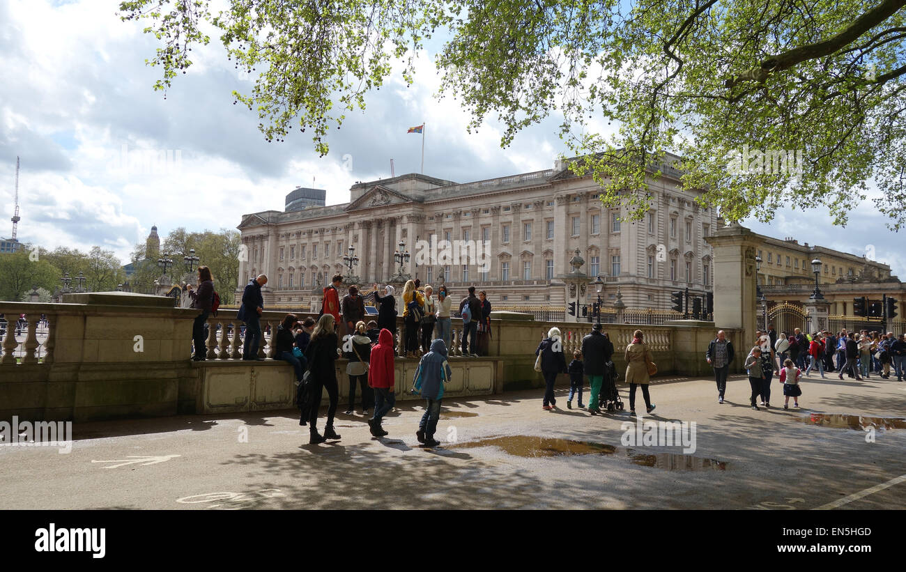 View of Buckingham Palace from Green Park and people walking by, in central London, England, UK Stock Photo