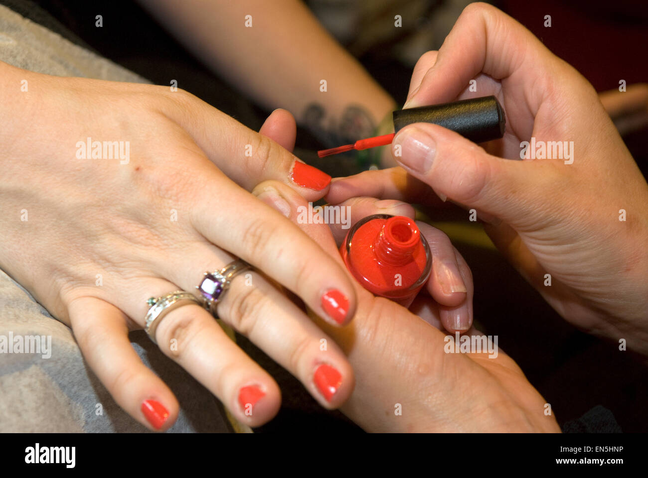 Young woman having her nails painted at a Spring lifestyle event