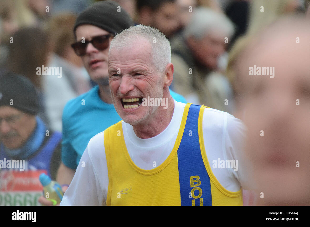 London Marathon 2015. Elderly male runner grimacing in pain Stock Photo