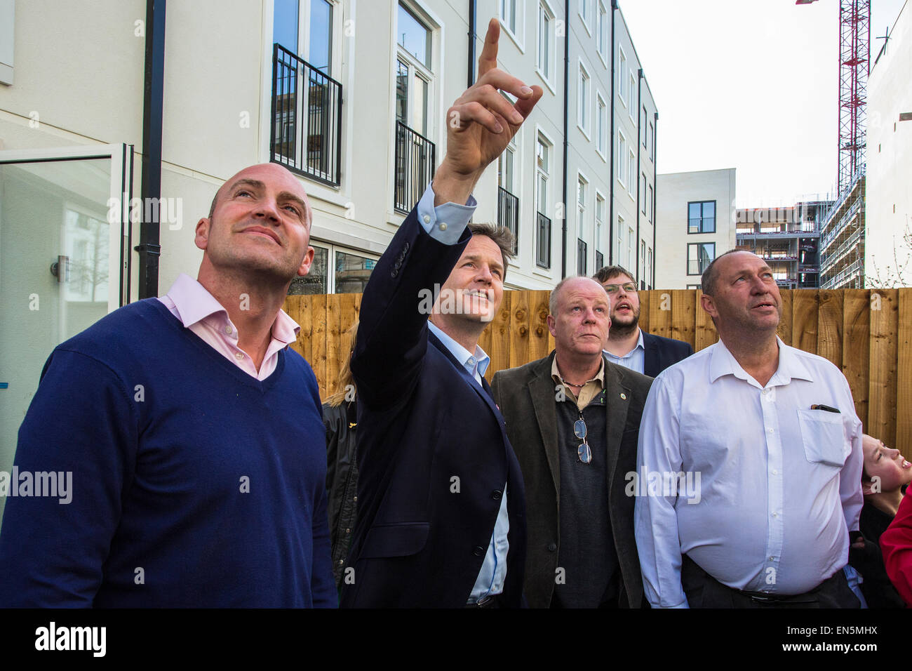 Bath, UK. 28th April, 2015. Nick Clegg pointing upwards when he visits a new housing development in Bath with local Liberal Democrat candidate Steve Bradley (left) alongside suppoters.  He talked to apprentices on the site.  He also met one year old local quadruple amputee Harmonie Rose whose family he is supporting in their campaign for a meningitis B vaccine.  Bath, UK. 28th April 2015. Credit:  Redorbital Photography/Alamy Live News Stock Photo