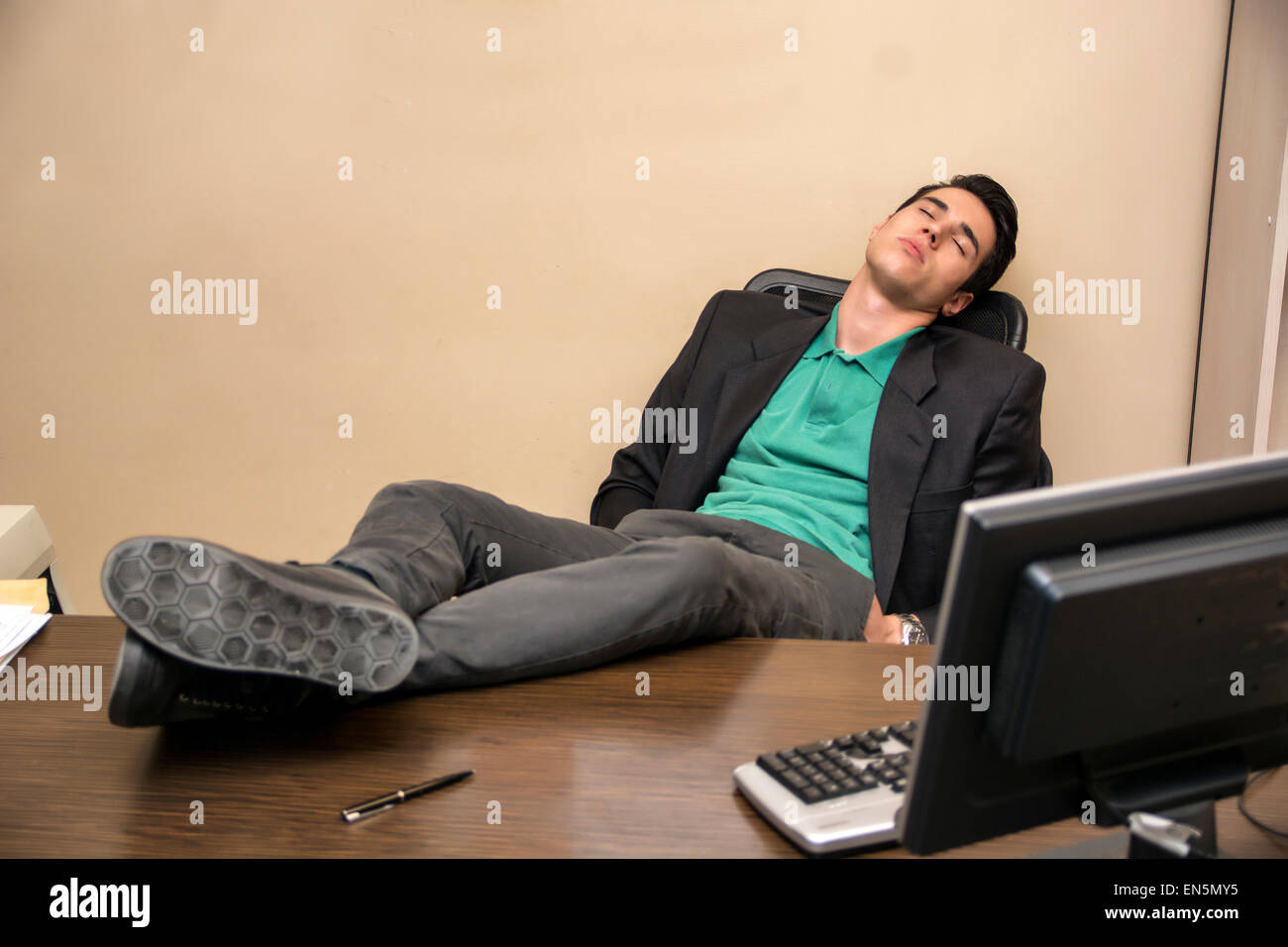 Overworked Tired Young Businessman Sleeping At His Desk Stock