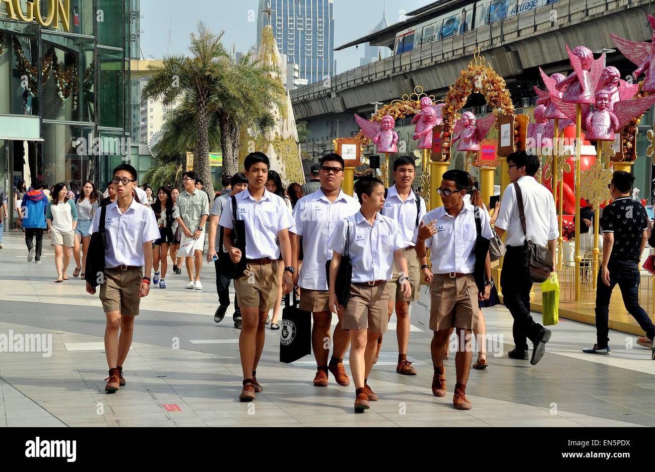 Bangkok, Thailand:  Thai school boys wearing their regulation white shirts and khaki shorts uniforms Stock Photo