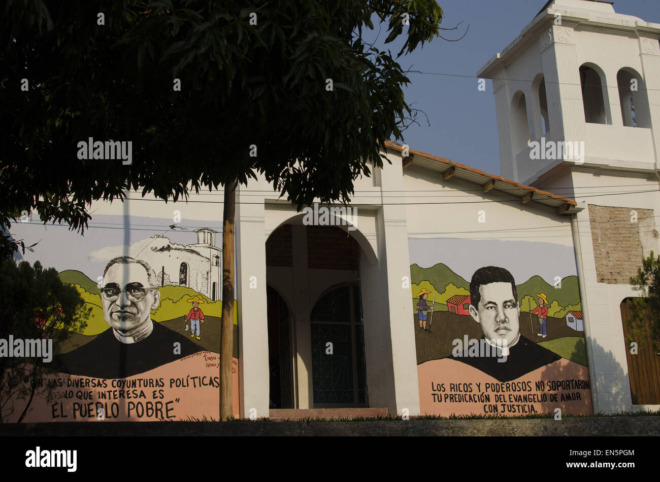 April 23, 2015 - Cinquera, CabaÃ±as, El Salvador - The facade of the Catholic Church in Cinquera, decorated with portraits of Archbishop of San Salvador 'scar Romero (left), assassinated on March 24, 1980, and Father Marcial Serrano (right), assassinated on November 28 of the same year. Largely destroyed during the Civil War, the town was repopulated with the peace process by former combatants and survivors who had fled to Honduras as refugees during the 1980s. © ZUMA Wire/ZUMAPRESS.com/Alamy Live News Stock Photo