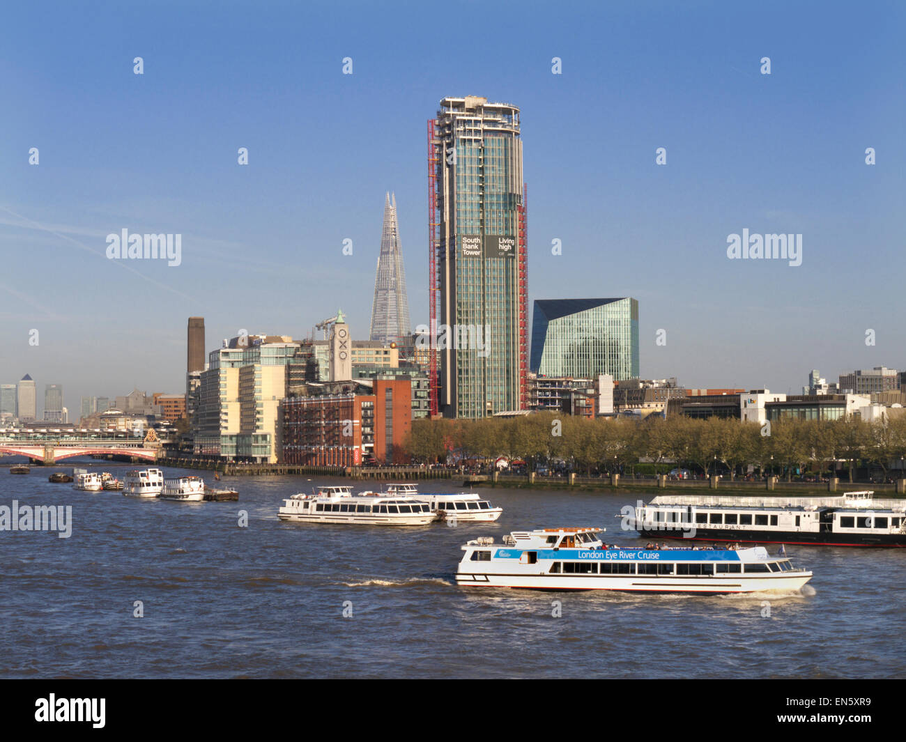 View from Waterloo Bridge with London Eye River Cruise boat and South Bank Tower, The Shard and Oxo behind SouthBank London Stock Photo