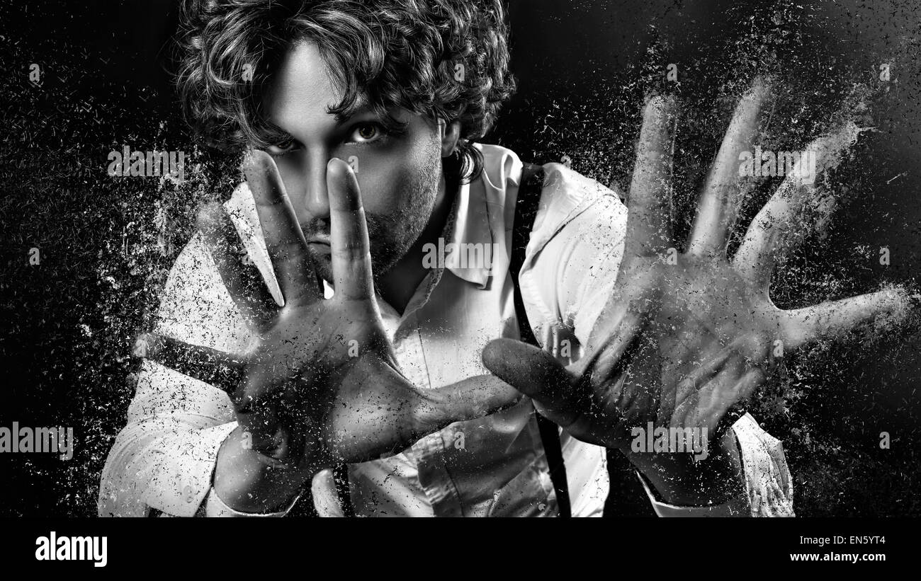 image of a man who performs magic with his hands Stock Photo