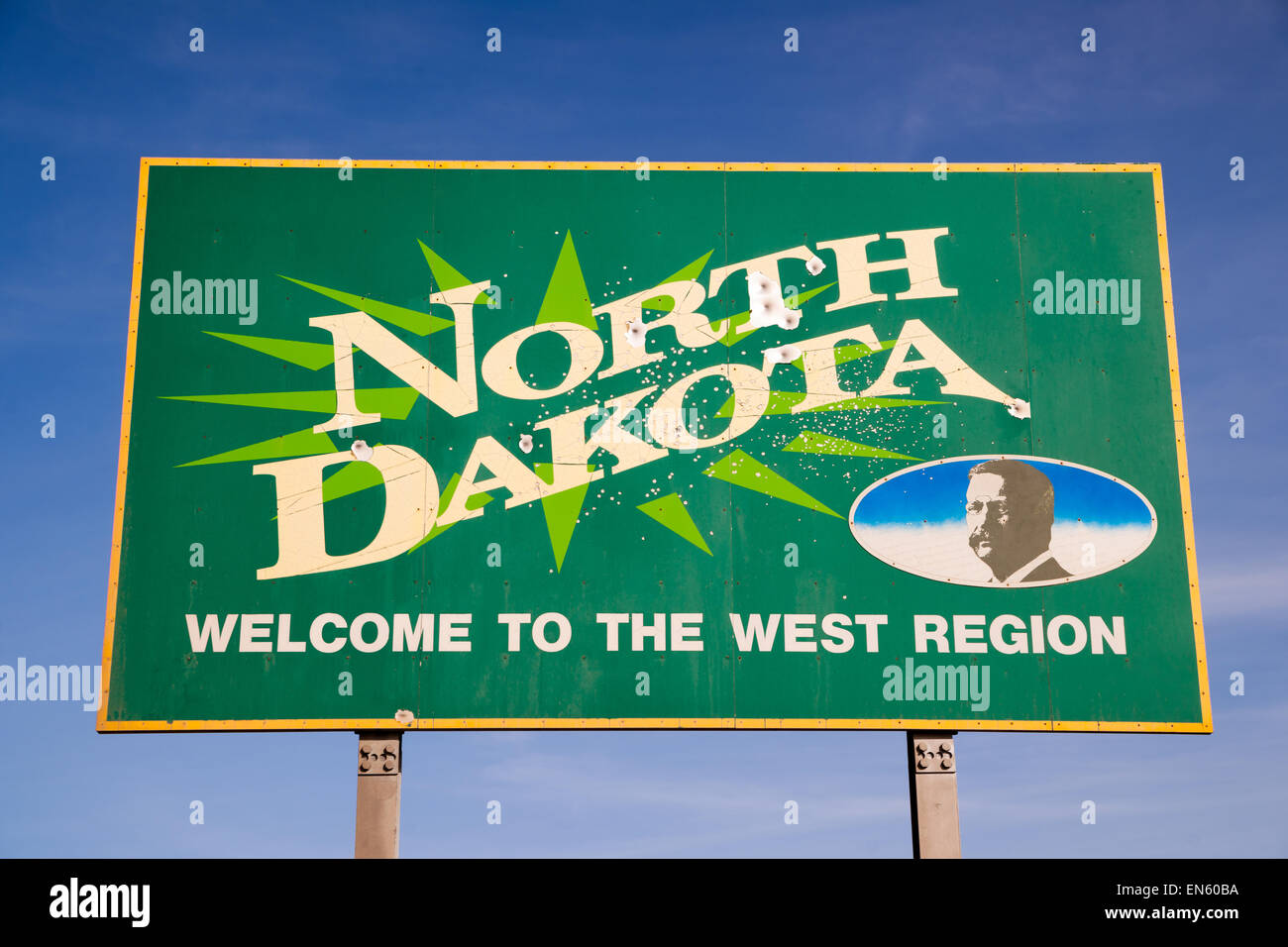 Bullet holes riddle the welcome sign for North Dakota Stock Photo