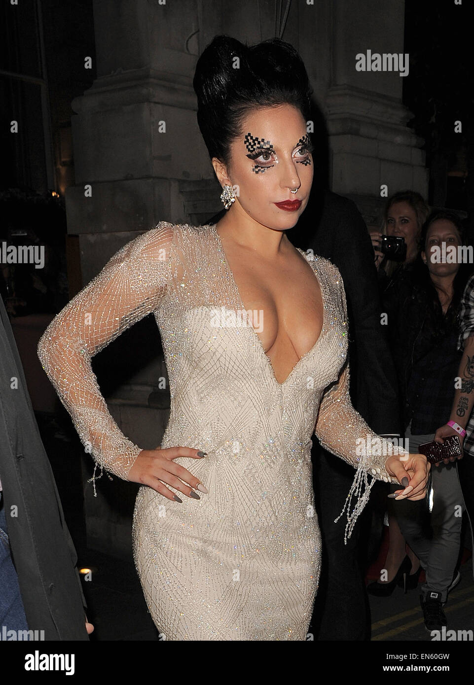 Lady Gaga displays ample cleavage as she leaves her London hotel
