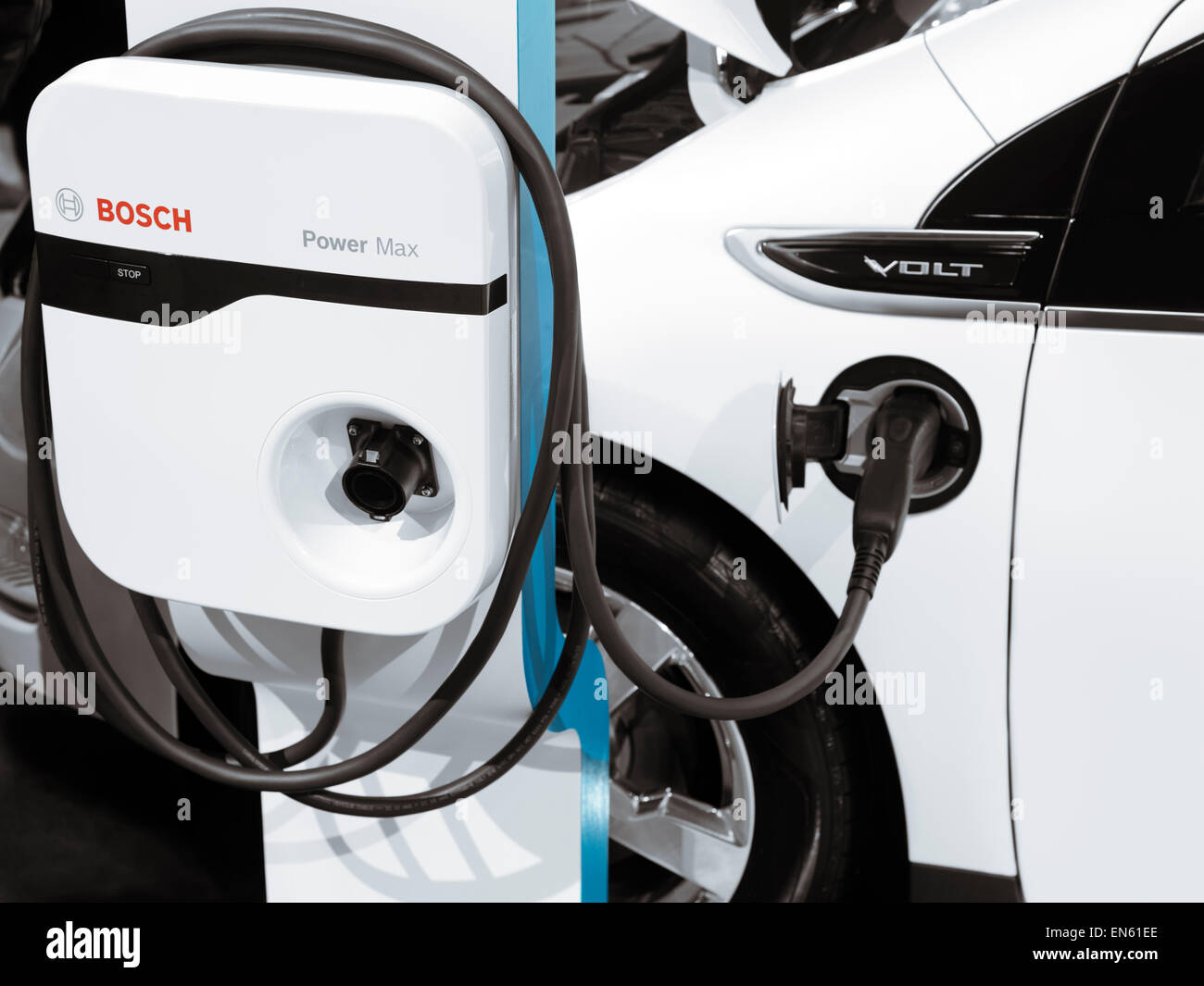 Chevrolet Volt hybrid electric car plugged in into a charging station Stock Photo