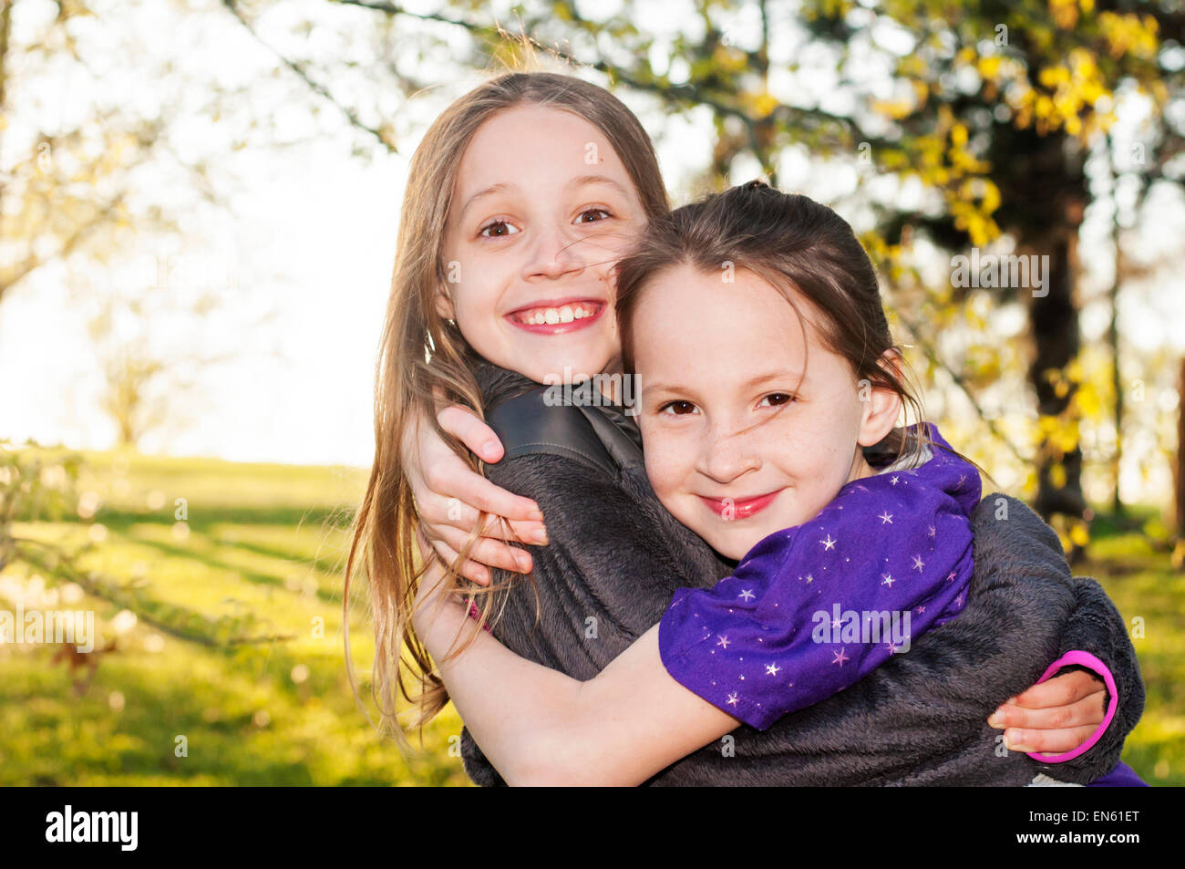 sisters smile hug Stock Photo