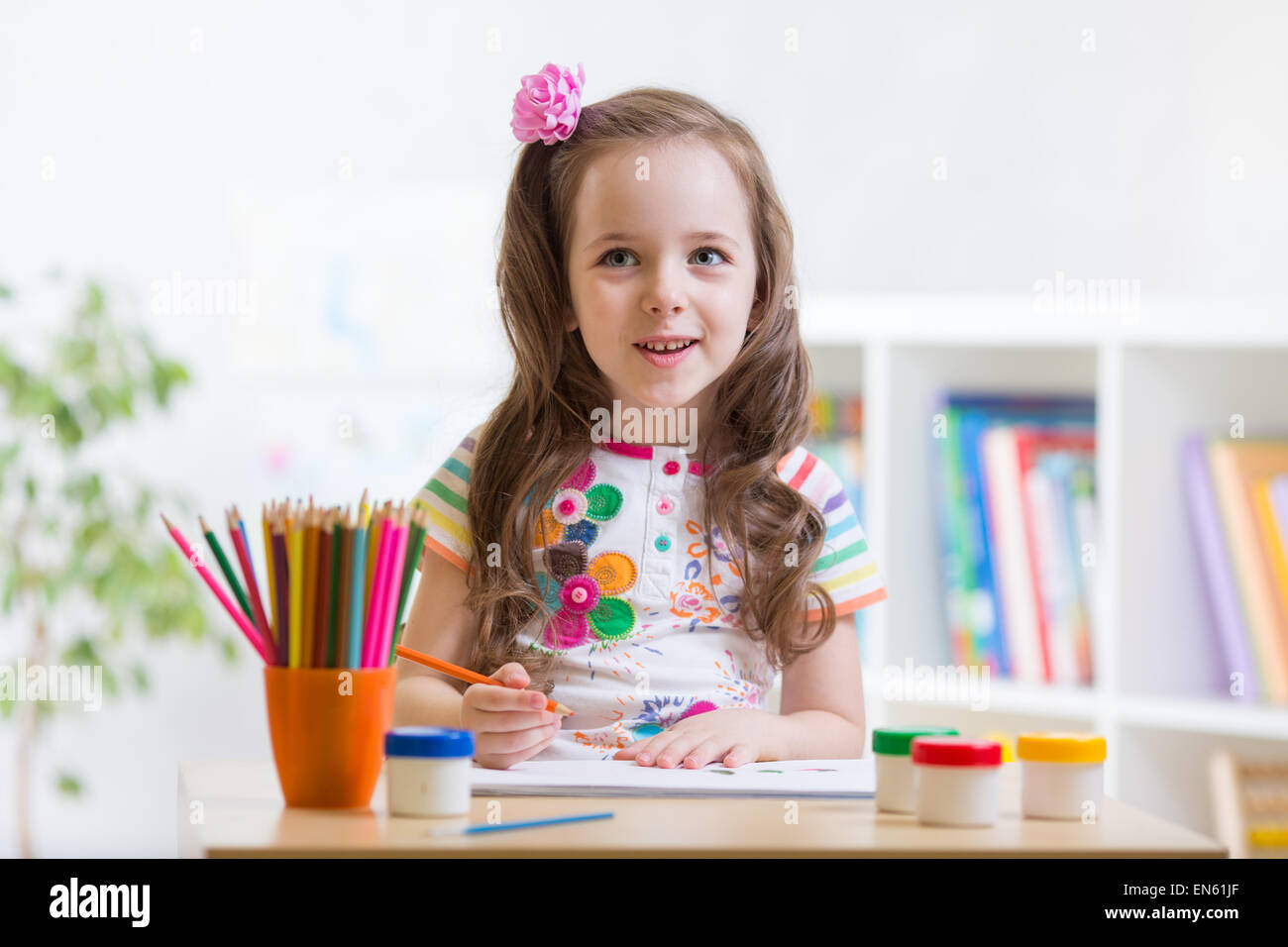 Cute little preschooler child girl drawing at house Stock Photo