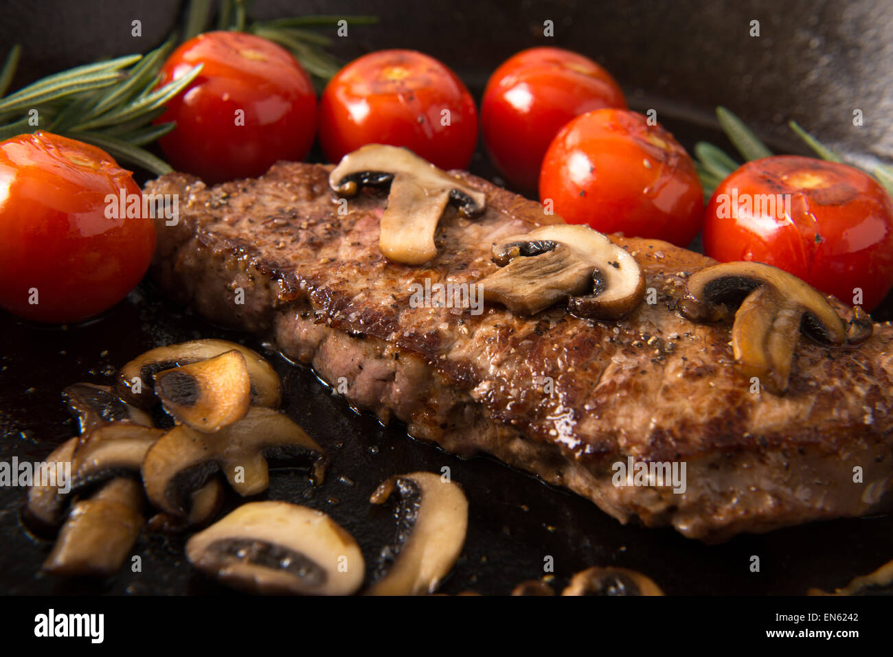 Grilling Strip Loin Steak in Cast Iron Frying Pan Steak is cooked and