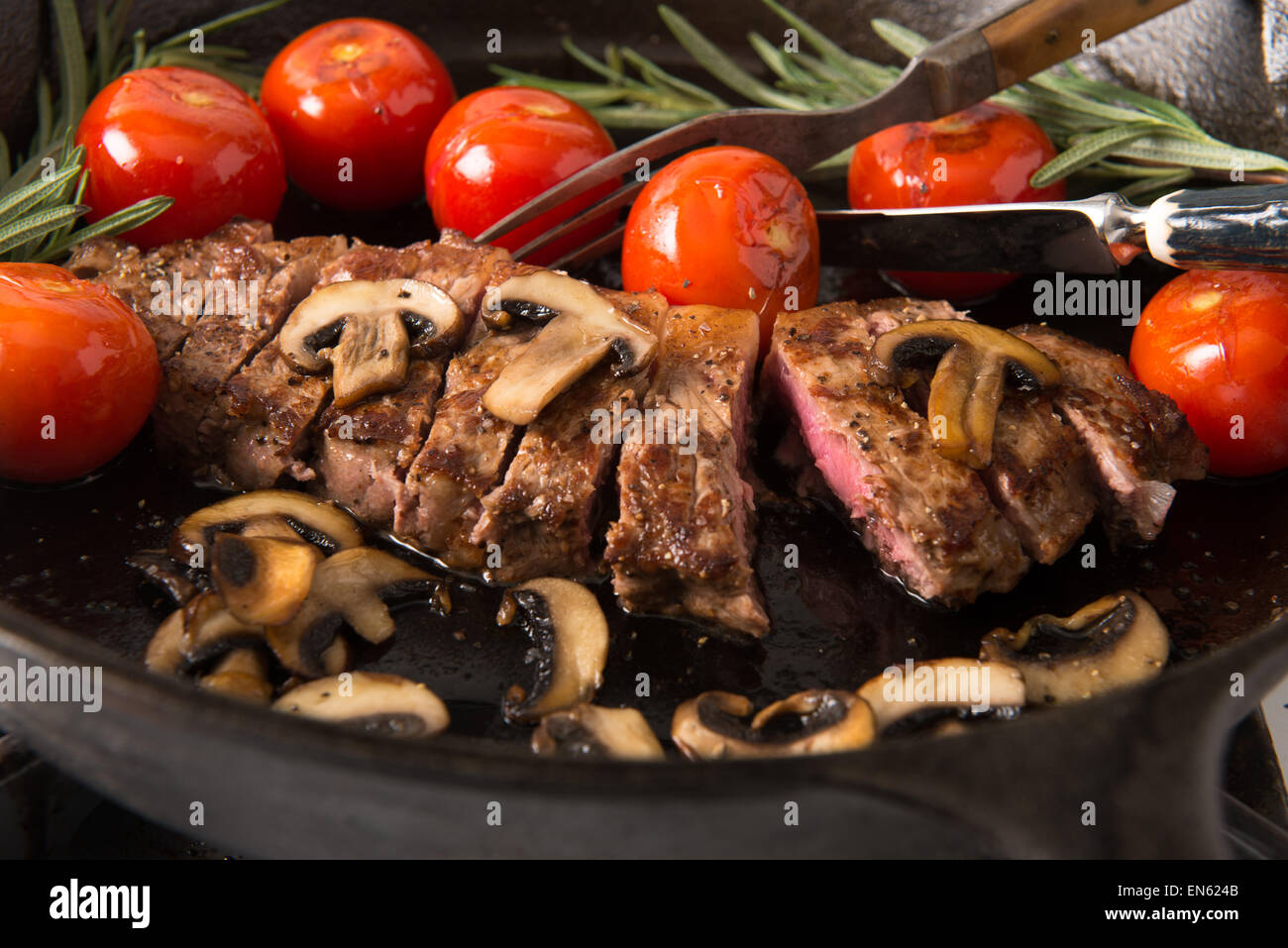 Grilling Strip Loin Steak in Cast Iron Frying Pan Steak is cooked and