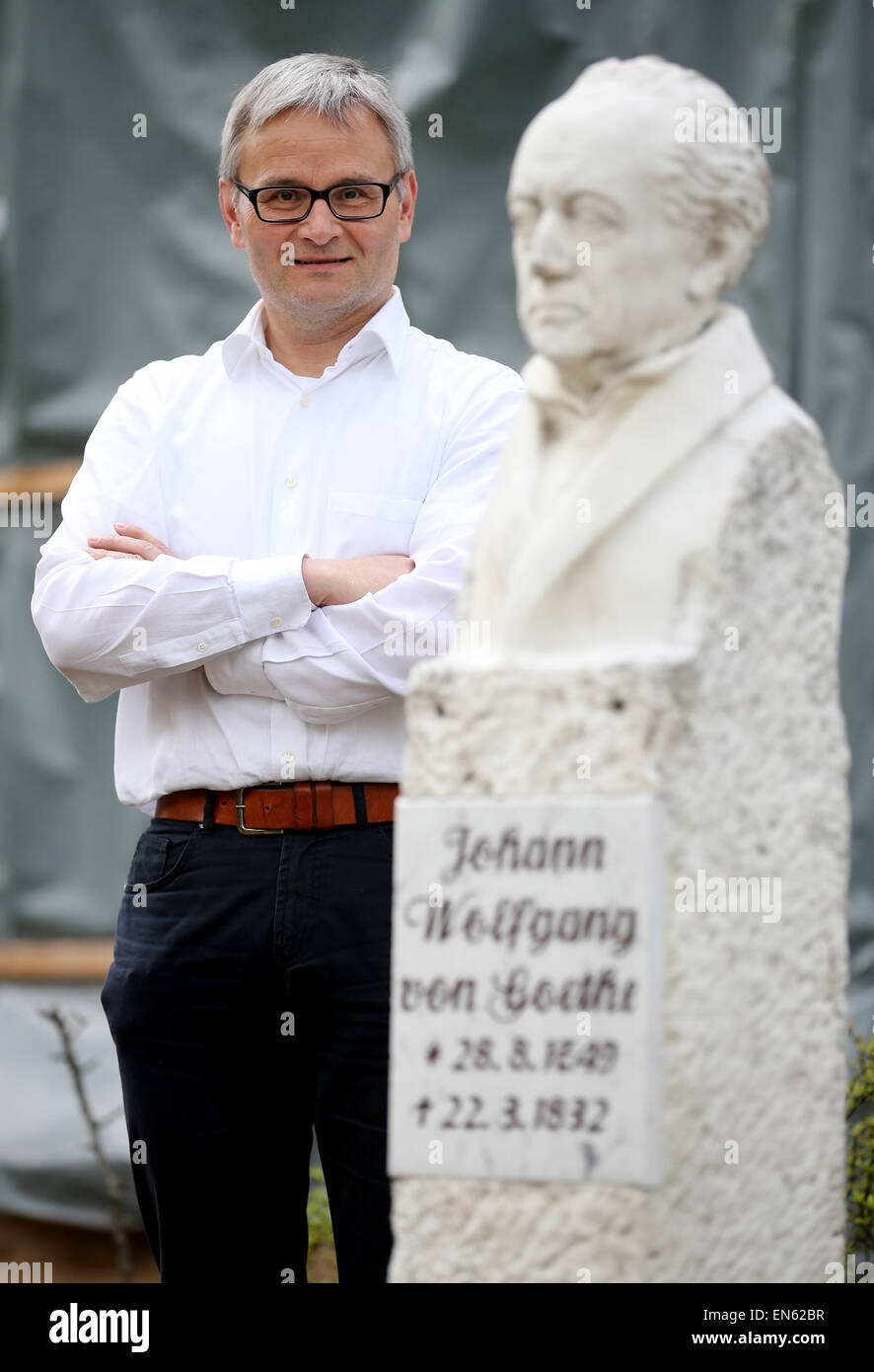 Bad Lauchstaedt, Germany. 28th Apr, 2015. Rene Schmidt, director of the historical cure facilities and of the Goethe theatre poses behind a bust of Goethe at the theatre in Bad Lauchstaedt, Germany, 28 April 2015. The venue that was designed and opened by Johann Wolfgang von Goethe more than 200 years ago is in need of redevelopment. The truss is affected by strong pest infestation including wet rottenness fungis and serpula lacrymans fungis. The renovation of the venue is to start from May during the running theatre business. Photo: Jan Woitas/dpa/Alamy Live News Stock Photo