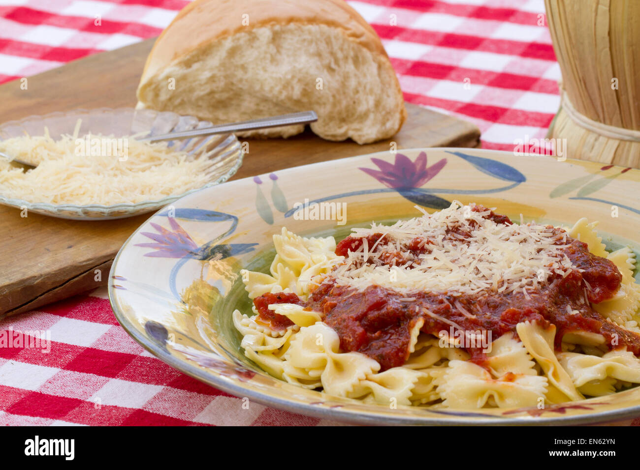 Italian pasta dinner served with Marinara sauce, parmesan cheese, over